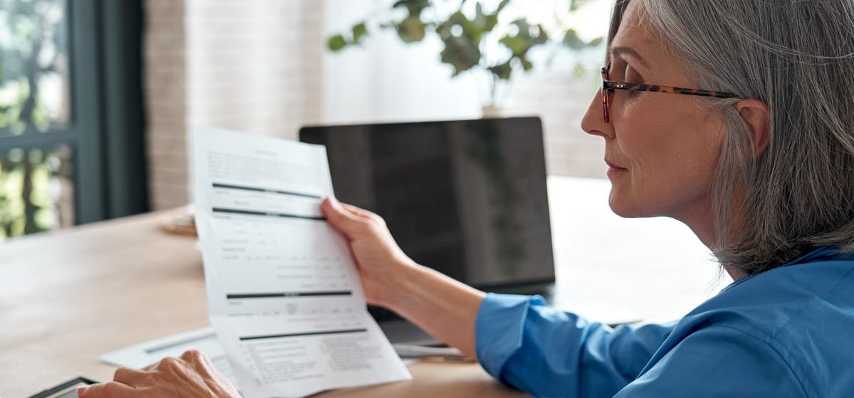 HR budgeting businesswoman using a calculator at her desk