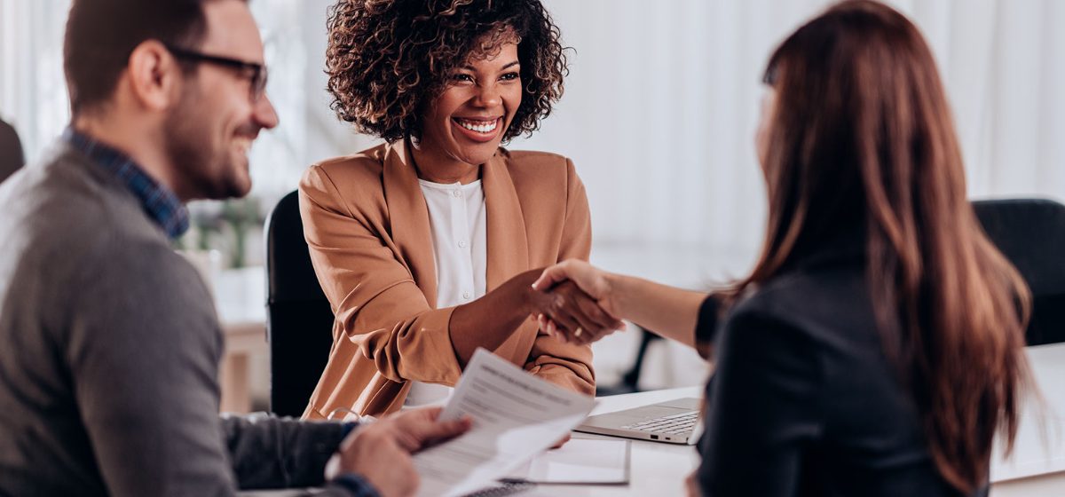 Four things to change for better recruitment - women shaking hands in job interview