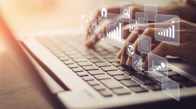 Businesswoman using laptop in data management