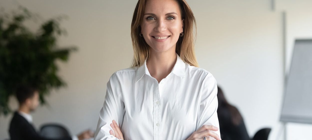 HR manager female professional manager standing arms crossed looking at camera