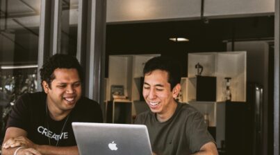 Two men looking at laptop