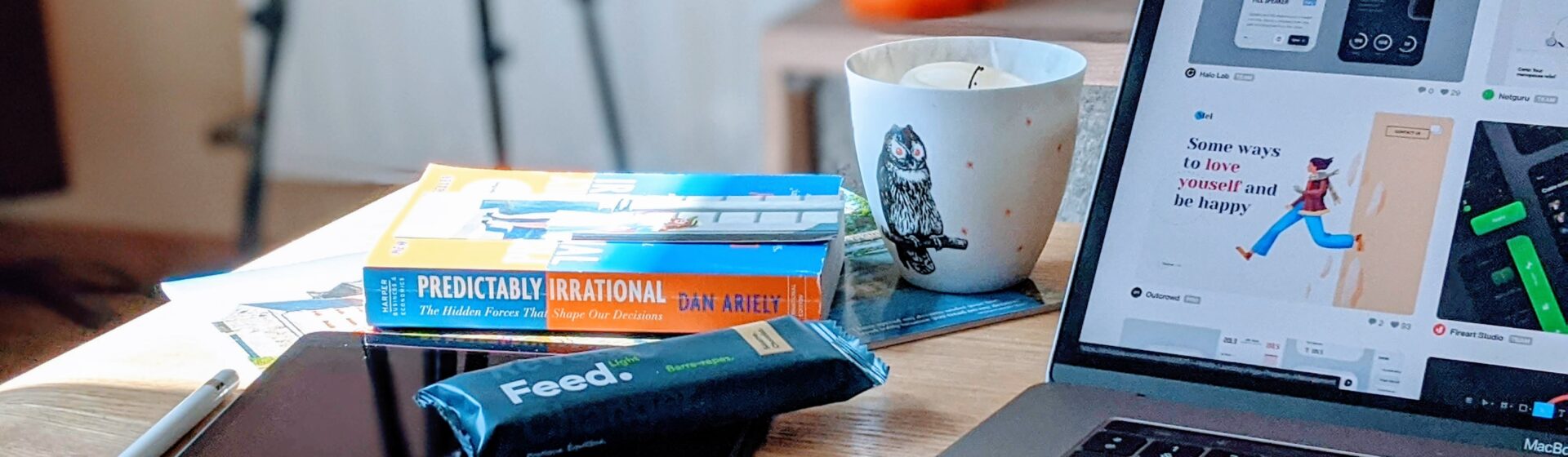 Desk with notes, laptop, and snacks