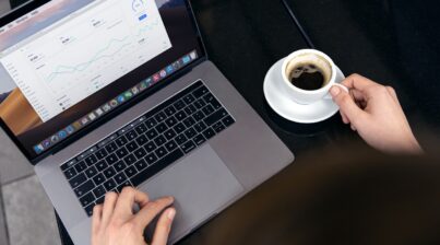 Data dashboard on a laptop with cup of coffee to the side