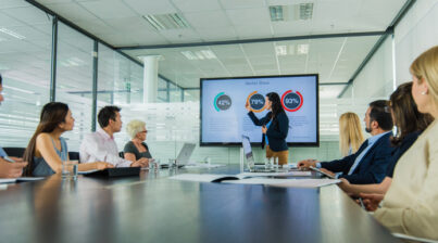 Businesswoman giving presentation in conference room.