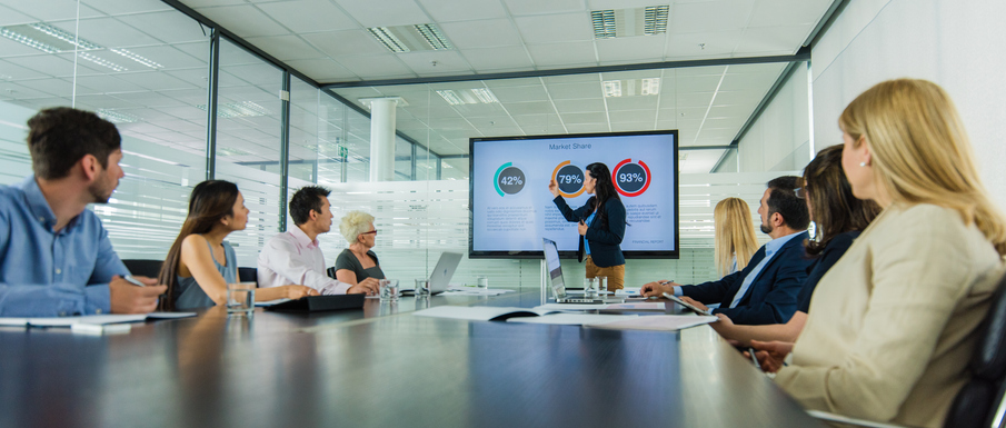 Businesswoman giving presentation in conference room.