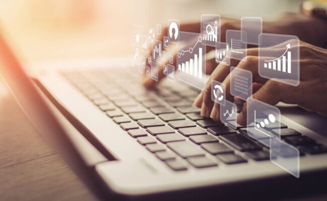 Businesswoman using laptop in data management